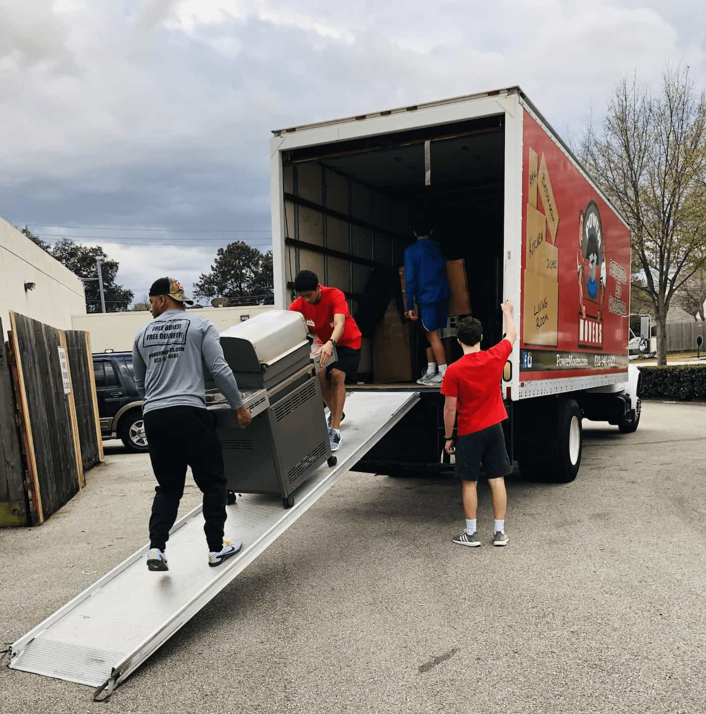 Moving team carefully preparing household boxes and furniture for transport